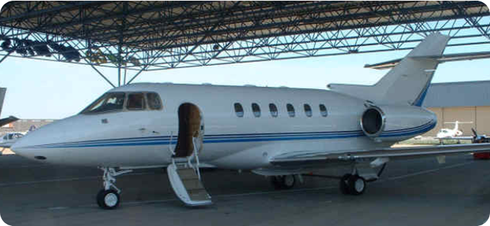 A small white plane parked at an airport.