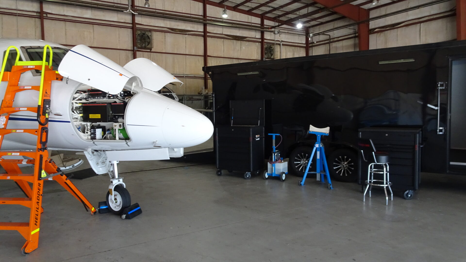 A hangar with an airplane and some tools.