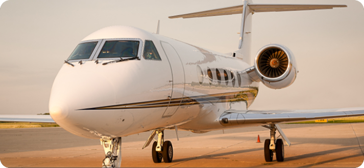 A white airplane sitting on top of an airport runway.